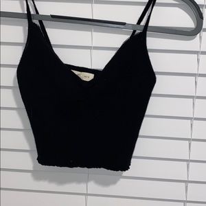 black tank top with rouching and a  frilled bottom